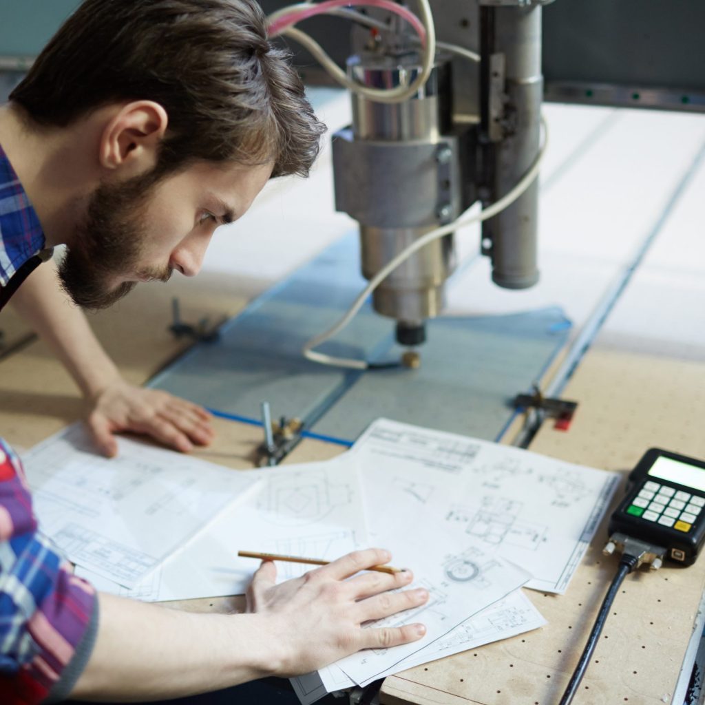 Young engineer concentrating on sketch of project